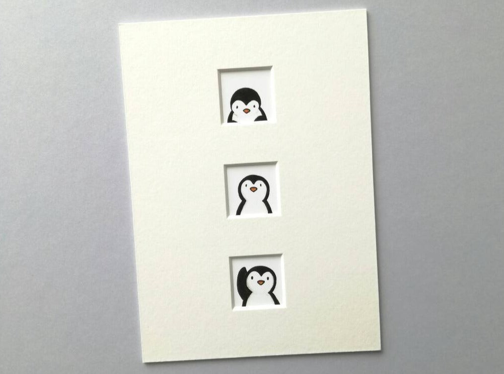 Peeking penguins print, three little wondows in a white mount waving and peeking up at each other#