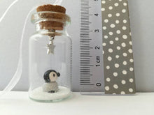 Load image into Gallery viewer, Miniature penguin decoration. Little pottery penguin chick in a glass bottle. Christmas mini penguin ornament
