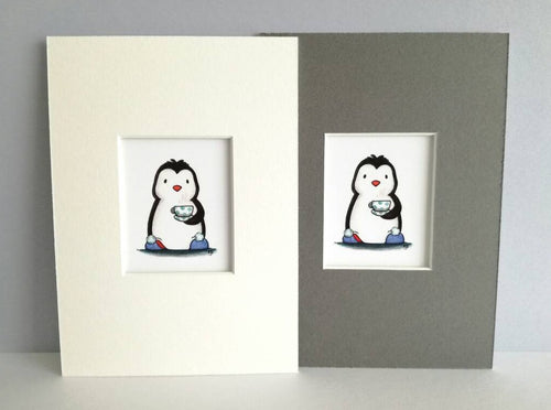 Cute black and white penguin, wearing blue pom pom slippers and holding tea, in a blue polka dot cup and saucer. Available in a coice of 7 x 5 inch grey or white mount