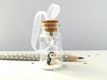 Load image into Gallery viewer, Miniature penguin decoration. Little pottery penguin in a glass bottle. Christmas penguin mini ornament
