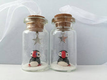 Load image into Gallery viewer, Puffin Christmas decoration. Little pottery puffin in a miniature glass bottle. Mini Christmas puffin ornament
