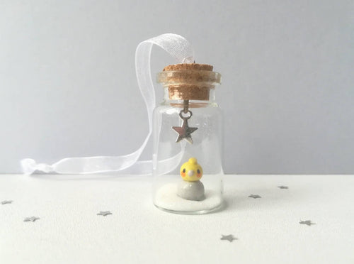 Cockatiel Christmas decoration. Little pottery cockatiel in a miniature glass bottle. Mini Christmas grey and yellow bird ornament