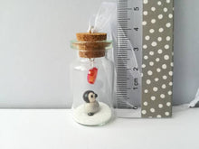 Load image into Gallery viewer, Miniature penguin chick gift. Little pottery penguin in a glass bottle. Red love heart mini penguin ornament
