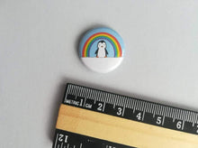 Load image into Gallery viewer, Rainbow and penguin badge next to a ruler to show the size
