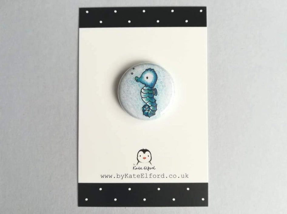 Mini seahorse button badge, the design is a little cute blue seahorse on a blue background