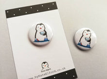 Load image into Gallery viewer, Little penguin button badge, a black and white penguin wearing slippers with pom poms and a polka dot cup and saucer
