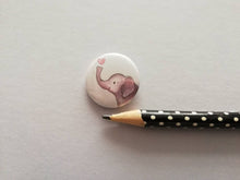 Load image into Gallery viewer, Mini round white button badge, it has an illustration of a grey elephant with a pink heart above it&#39;s trunk
