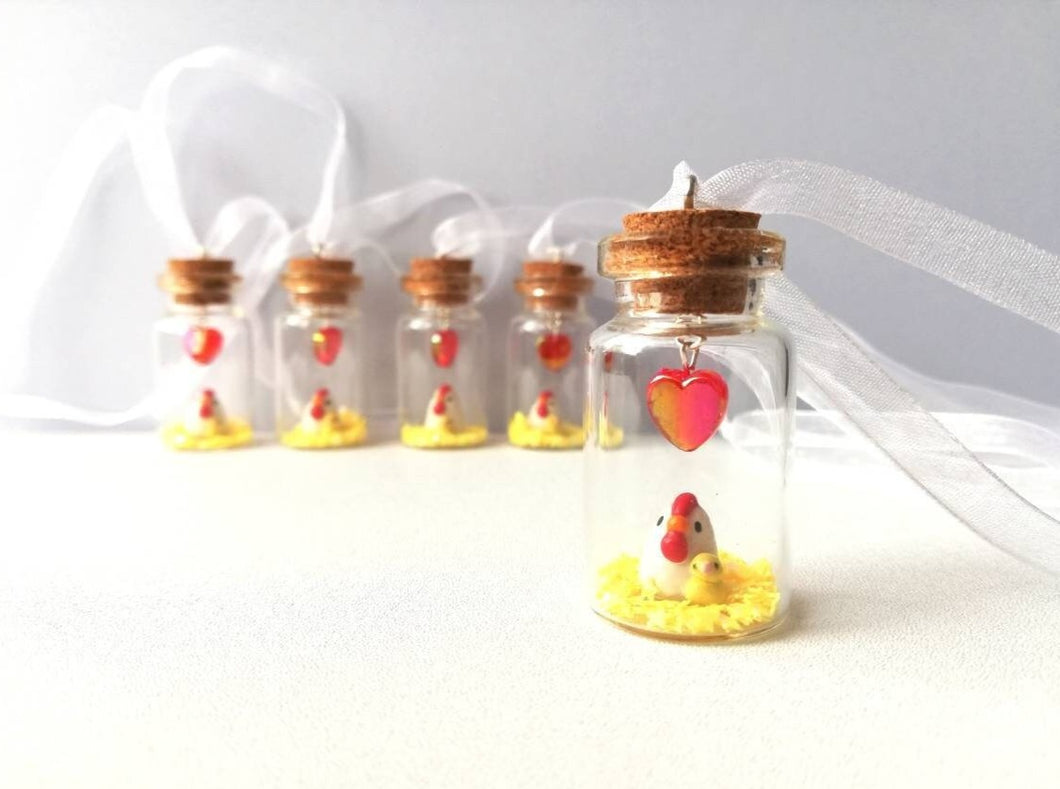 Miniature chicken and chick decoration. Little pottery white hen in a glass bottle. Mini ornament. Easter tree chick