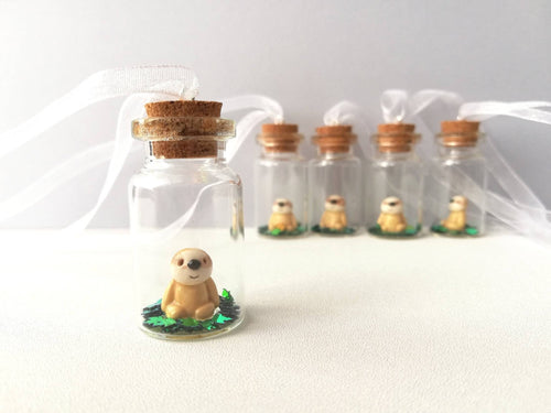 Miniature sloth ornament. Little pottery sloth decoration in a glass bottle. Christmas mini sloth ornament