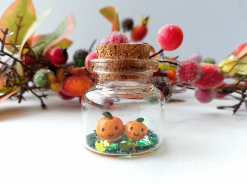 Miniature pumpkins Halloween decoration. Little pottery pumpkins in a glass bottle, with or without hook and ribbon, mini autumn ornament