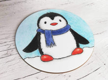 Load image into Gallery viewer, Coaster. Cute penguin in the snow wearing a blue scarf
