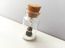 Load image into Gallery viewer, Miniature mole decoration. Little pottery hedgehog in a glass bottle. Christmas mole, snow and star ornament
