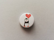 Load image into Gallery viewer, A mini button badge, with an illustration of a black and white penguin holding a red heart shaped balloon
