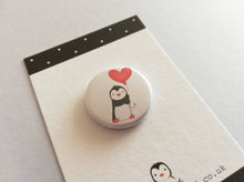 Load image into Gallery viewer, A mini button badge, with an illustration of a black and white penguin holding a red heart shaped balloon
