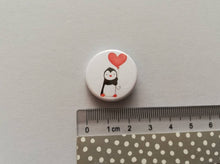 Load image into Gallery viewer, A mini button badge, with an illustration of a black and white penguin holding a red heart shaped balloon
