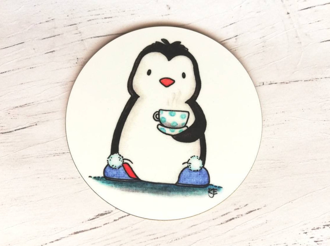 Penguin coaster. A black and white penguin on a white background. Penguin is wearing blue slippers with pom poms on the toes, and is holding a polka dot cup and saucer