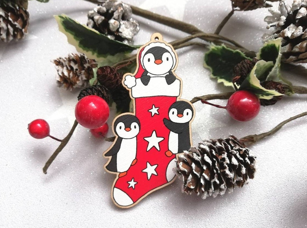 Penguin Christmas stocking decoration. Wooden penguins Christmas tree ornament. Red and white stocking with stars, eco friendly wood