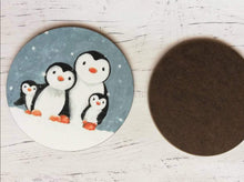Load image into Gallery viewer, Penguin coaster. Family of four penguins painting in the snow. This shows the back and front of the coaster
