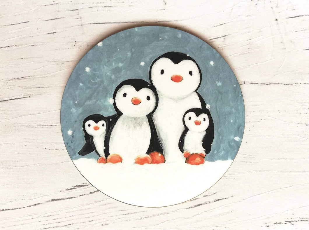 Penguin coaster. Family of four penguins painting in the snow