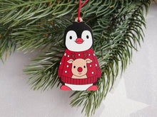 Load image into Gallery viewer, Penguin reindeer jumper decoration. Little wooden penguin wearing a blue or red jumper Christmas ornament, responsibly resourced wood
