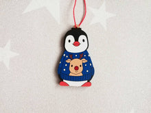 Load image into Gallery viewer, Penguin reindeer jumper decoration. Little wooden penguin wearing a blue or red jumper Christmas ornament, responsibly resourced wood
