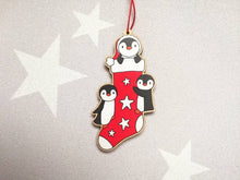 Load image into Gallery viewer, Penguin Christmas stocking decoration. Wooden penguins Christmas tree ornament. Red and white stocking with stars, eco friendly wood
