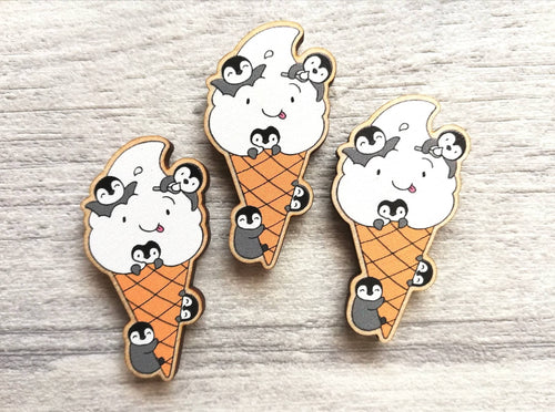 Small wooden, happy ice cream magnet, there are five little grey penguin chicks playing on the ice cream and cone
