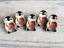 Load image into Gallery viewer, Penguin and pumpkin pin, grey penguin chick wooden pin brooch, Responsibly resourced wood, eco friendly. Halloween, autumn, fall badge
