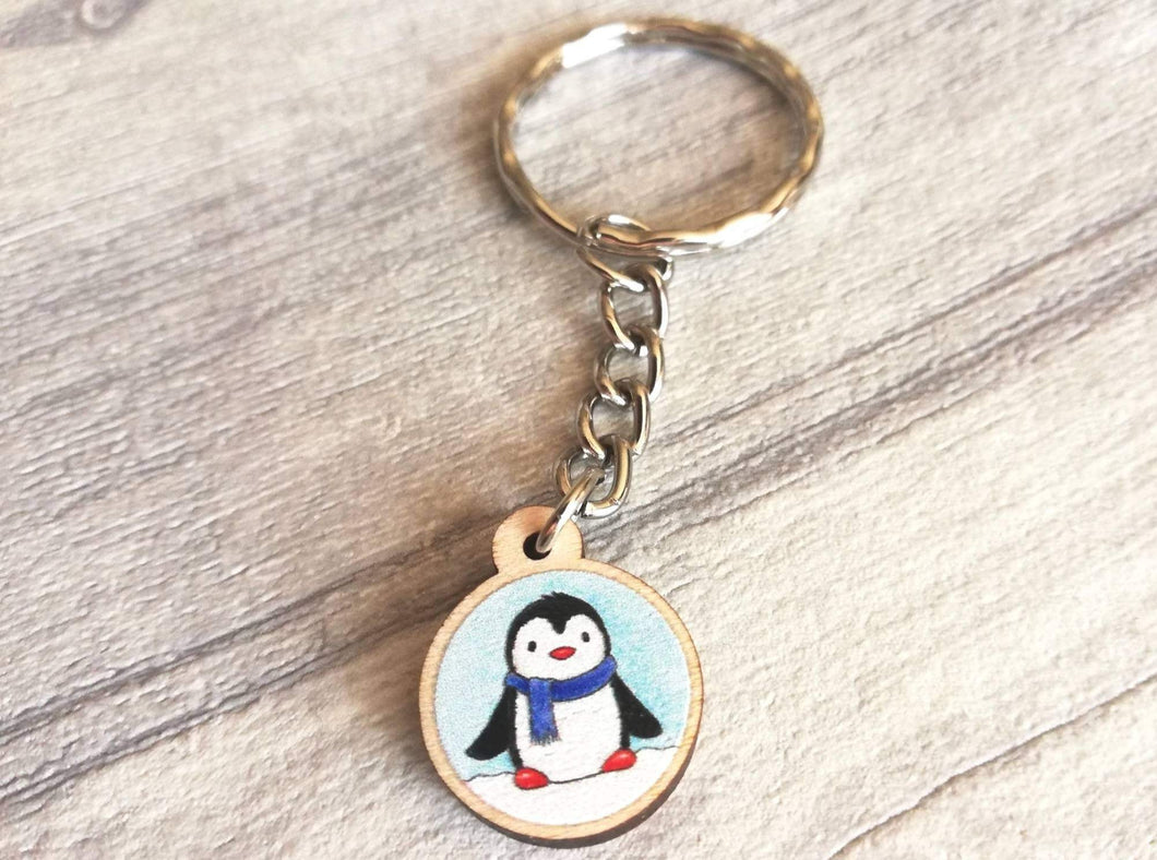 Little penguin keyring, cute mini tag, blue wooden key chain, penguin wearing a scarf in snow,ethically sourced wood, eco friendly charm