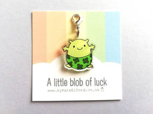 Load image into Gallery viewer, A little blob of luck stitch marker. Recycled acrylic charm with a silver plated lobster clasp. Blob is a happy little character wearing four leaf clover lucky pants.
