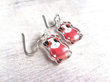 Load image into Gallery viewer, Clear recycled guinea pig earrings, wearing red jumpers, scarves and a Christmas santa hat
