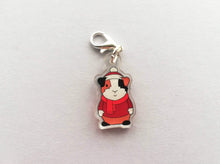 Load image into Gallery viewer, Little clear acrylic guinea pig stitch marker. It is made from recycled acrylic, the guinea pig is wearing a red hat, jumper and scarf
