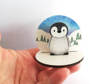 Load image into Gallery viewer, Penguin chick wooden ornament, little wood standee. Ethically sourced wood, penguin in the snow
