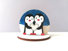 Load image into Gallery viewer, Penguins, pebble heart, wooden ornament, small penguin cake topper. Ethically sourced wood, love birds
