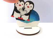 Load image into Gallery viewer, Penguins, pebble heart, wooden ornament, small penguin cake topper. Ethically sourced wood, love birds
