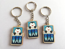 Load image into Gallery viewer, Penguin keyring, sleeping penguin sardine tin, lightweight wooden key fob, ethically sourced wood, penguin key chain, cute bag charm
