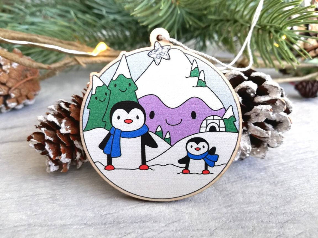 Penguin Christmas decoration. Snowy purple mountains small wooden ornament. Ethically sourced wood. Cute penguins Christmas tree ornaments.