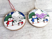 Load image into Gallery viewer, Penguin Christmas decoration. Snowy purple mountains small wooden ornament. Ethically sourced wood. Cute penguins Christmas tree ornaments.

