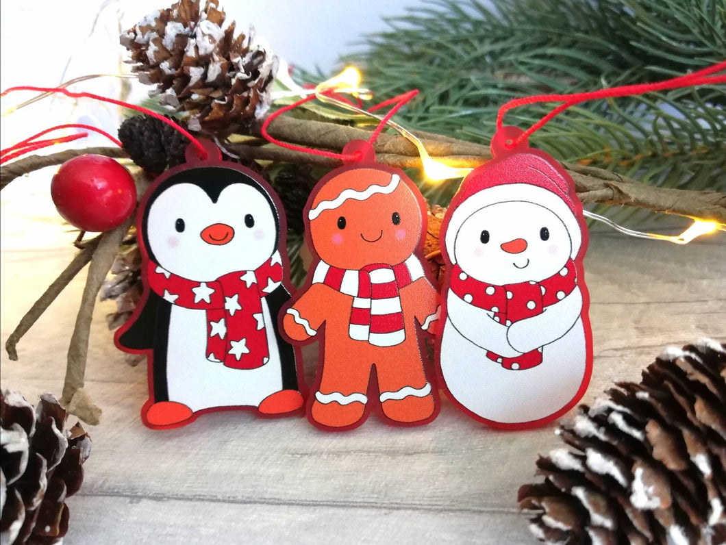 Penguin Christmas decorations. Set of three, frosted red acrylic penguin, snowman and gingerbread man. Cute Christmas tree ornaments.