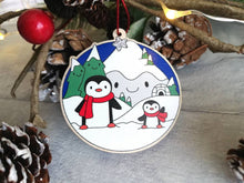 Load image into Gallery viewer, Penguin Christmas decoration. Snowy mountains small wooden ornament. Ethically sourced wood. Cute penguins Christmas tree ornaments.
