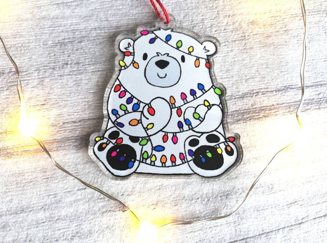Polar bear Christmas tree decoration. Recycled acrylic Christmas ornament, polar bear tangled up in rainbow coloured fairy lights