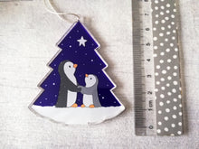 Load image into Gallery viewer, Penguin and star decoration. Eco friendly, purple recycled acrylic Christmas ornament, penguins in the snow
