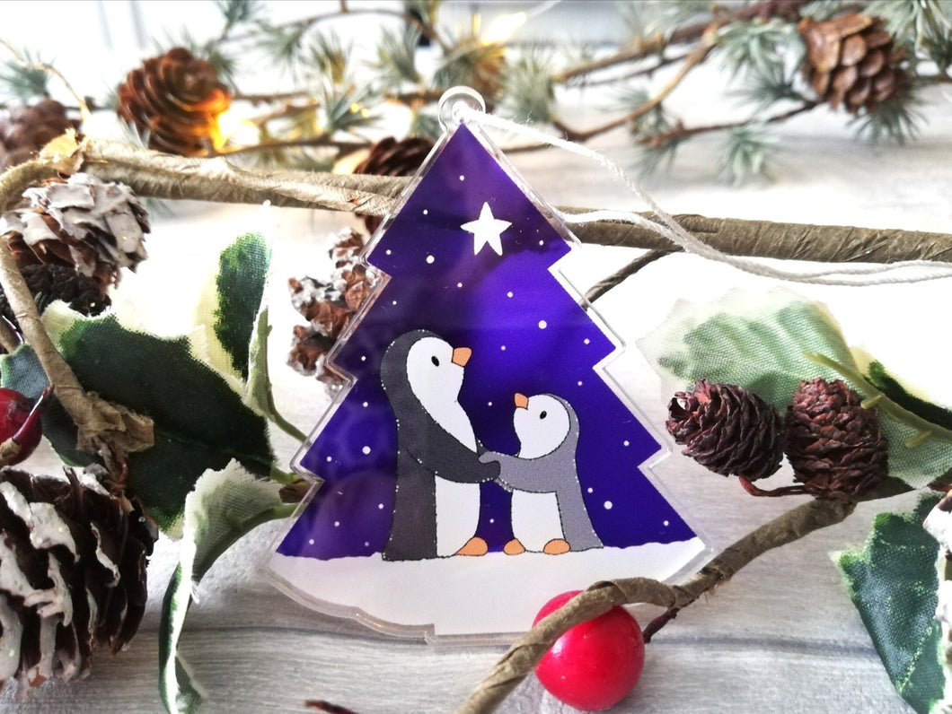 Penguin and star decoration. Eco friendly, purple recycled acrylic Christmas ornament, penguins in the snow